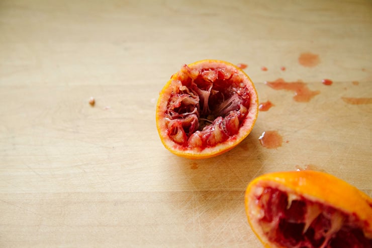 Image shows a squeezed blood orange half.