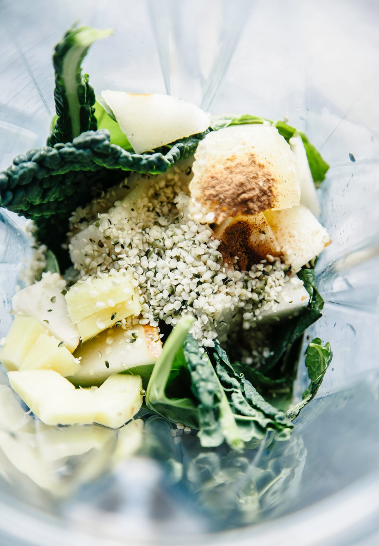 An overhead shot of ingredients in a blender jar for a smoothie, pre-blending.