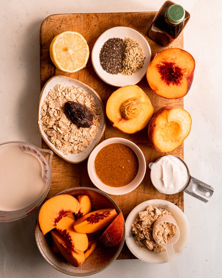 An overhead shot of ingredients used in a peach smoothie recipe.