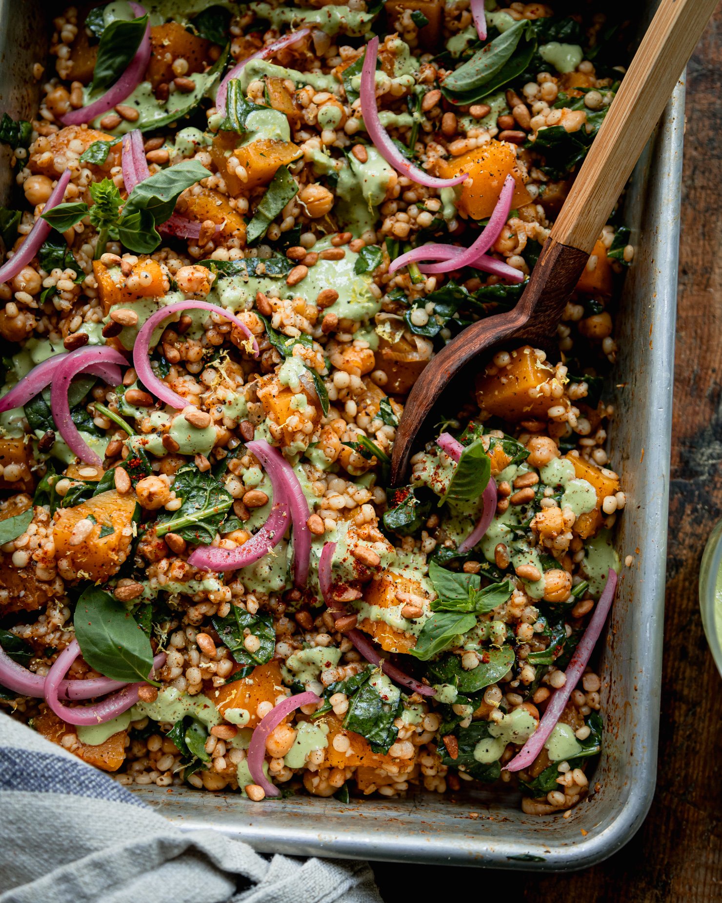 https://thefirstmess.com/wp-content/uploads/2023/09/baked-pearl-couscous-and-butternut-squash-basil-tahini-02.jpg