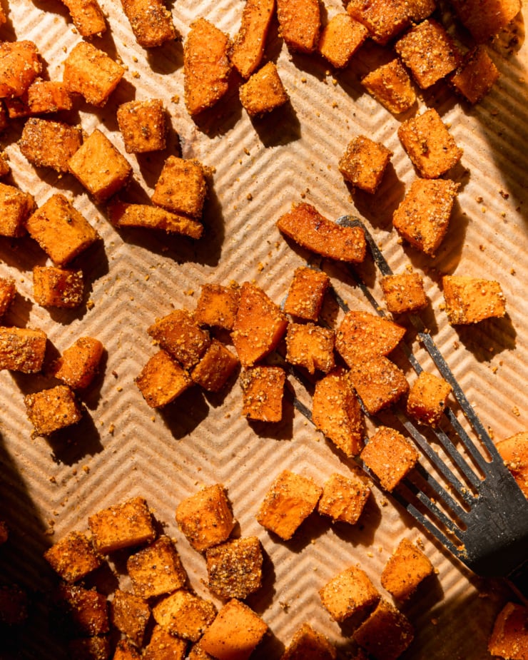 Overhead lens shows a cube of roasted butternut squash with spices.