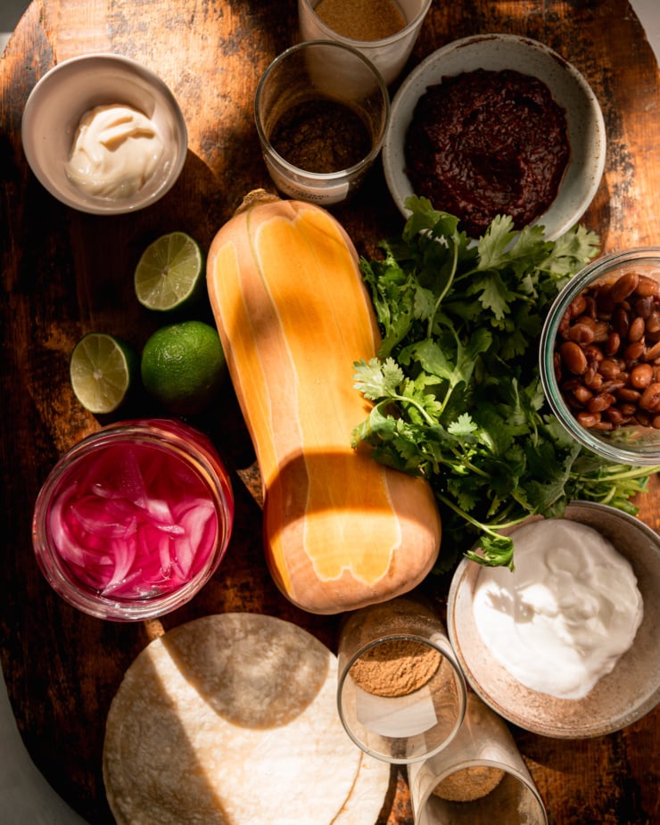 An elevated shot shows the ingredients of the vegetarian butternut squash taco on the wooden board.