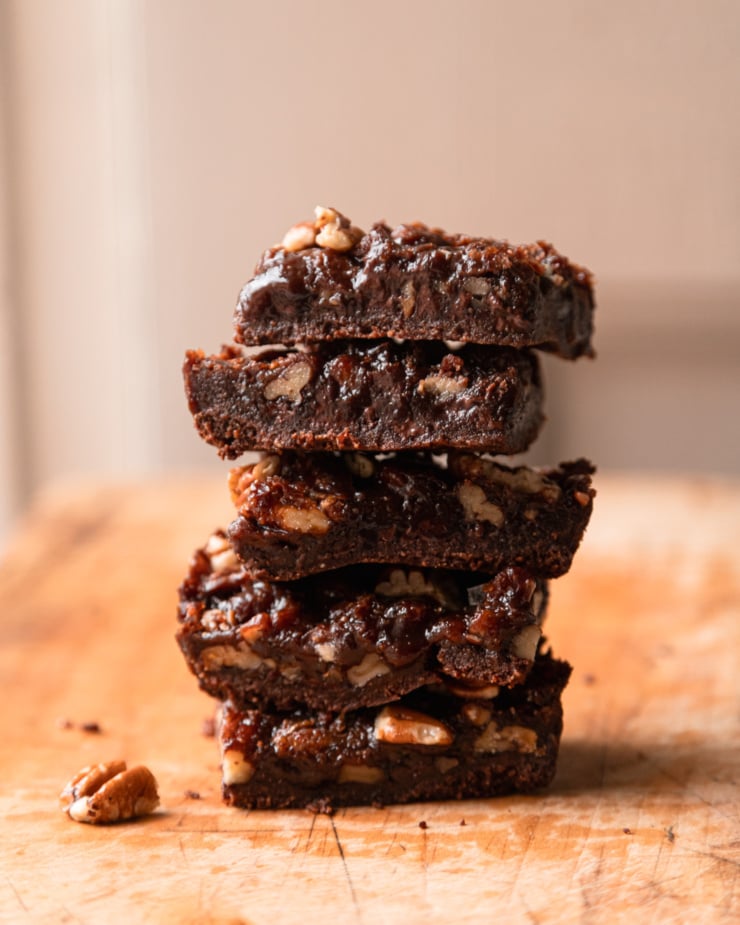 The front photo shows a stack of chocolate pecan bars on a wooden cutting board.
