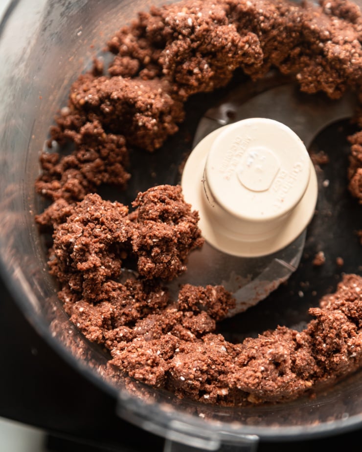 Top view showing the gluten-free and vegan chocolate crust mixture in the food processor.