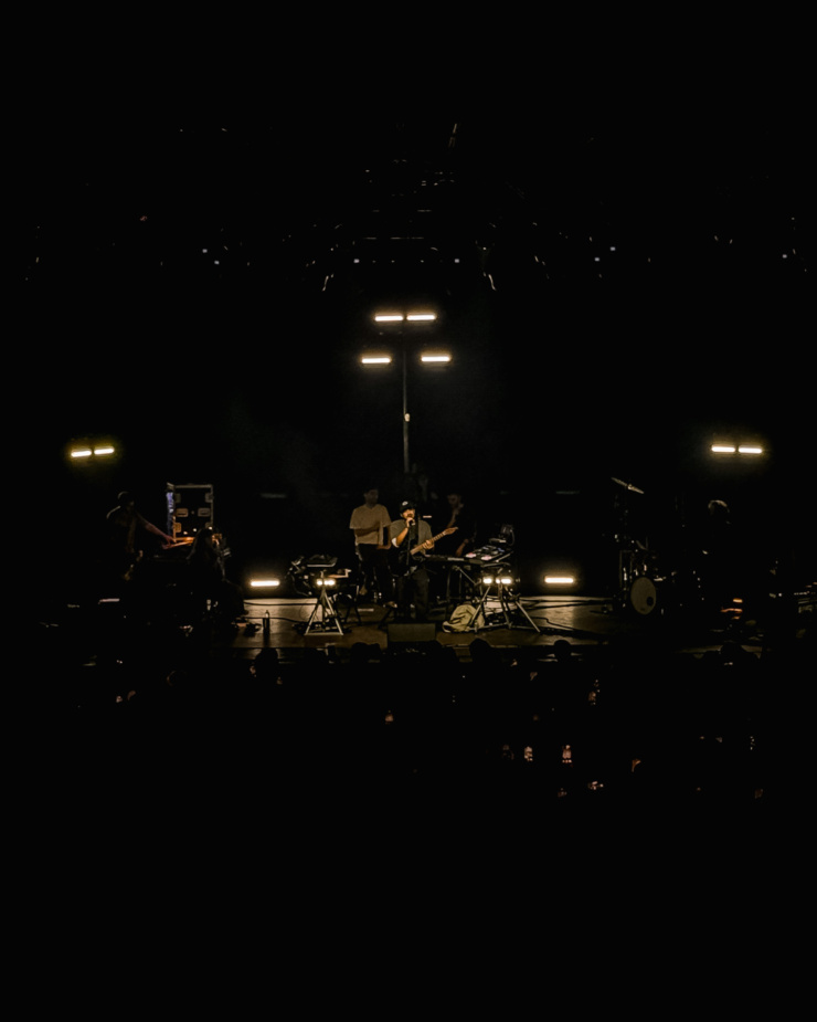 A head-on shot shows the artist Dijon performing on stage at Toronto's History venue.