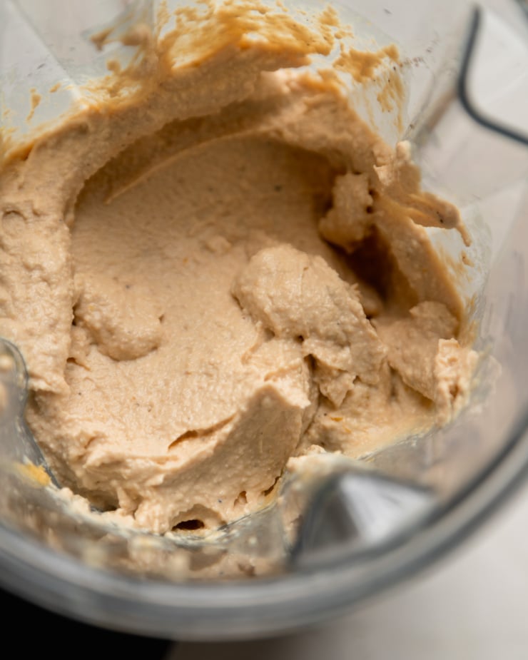 Top view shows blending tofu and cashew ricotta in a blender jar.