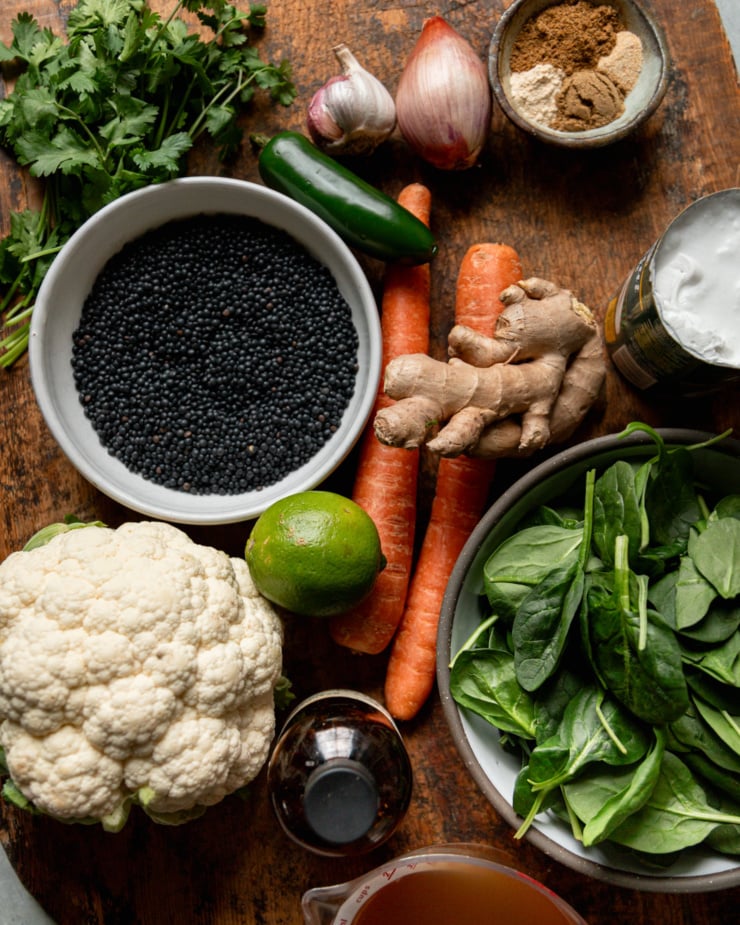 An overhead shot shows ingredients needed for a stewed lentils and roasted vegetable dish.