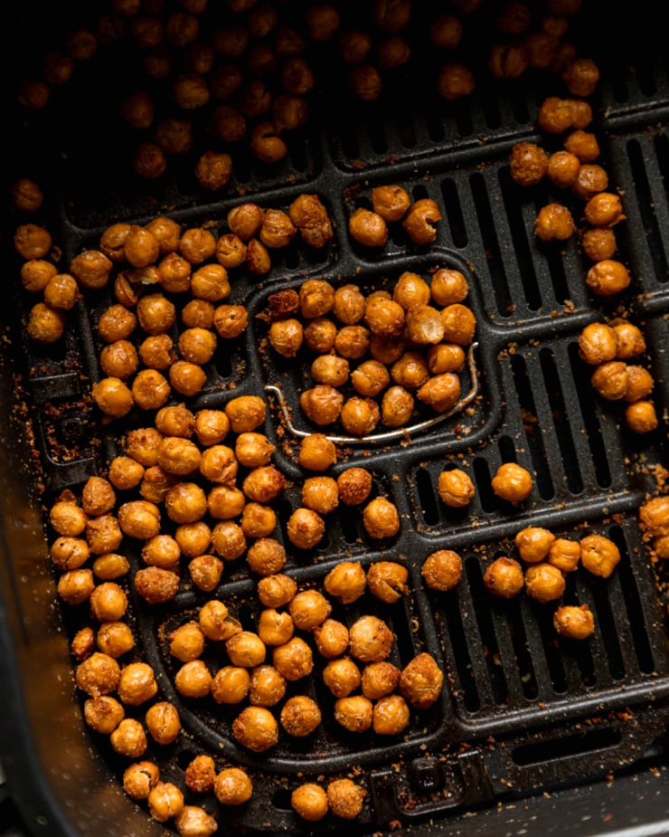 An overhead shot shows crispy chickpeas in an air fryer basket.
