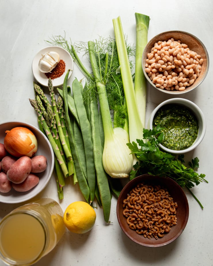 An overhead shot shows ingredients needed for a vegan soup recipe.