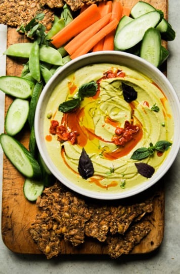 Garlic white bean dip with basil and Calabrian chili, served with carrots, cucumbers, snap peas, and seeded crackers.