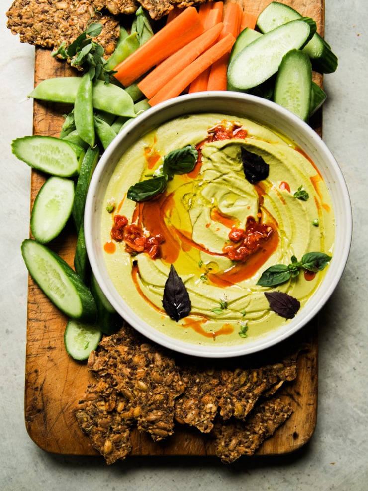 Garlic white bean dip with basil and Calabrian chili, served with carrots, cucumbers, snap peas, and seeded crackers.